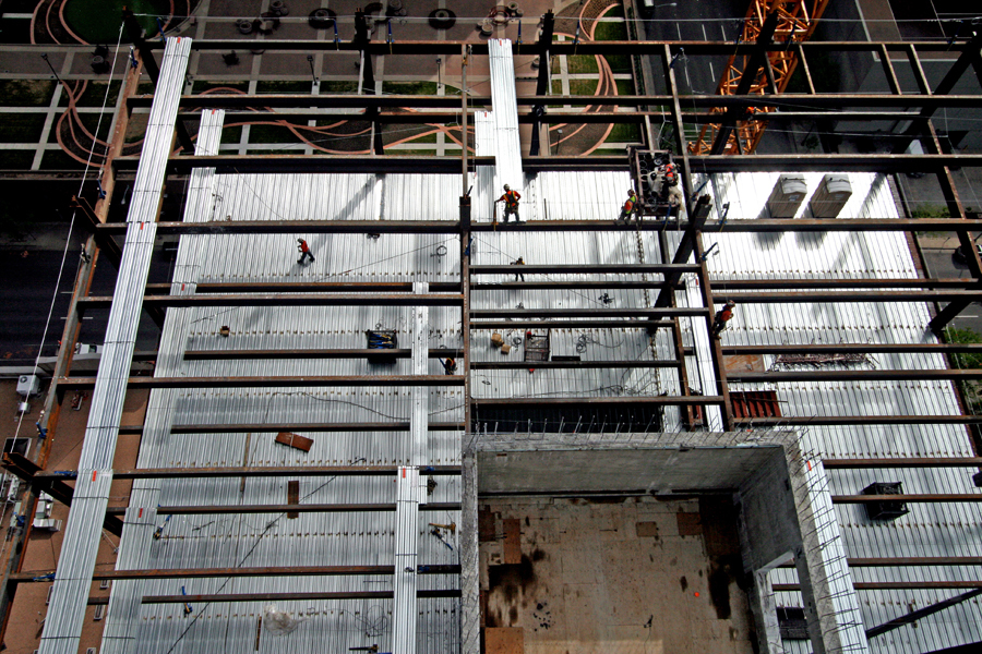 Aerial view of steel workers securing beams. :  : Christopher Davies Photography