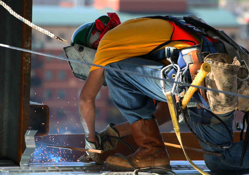 Steel welder secures flooring on the 21st floor.  :  : Christopher Davies Photography