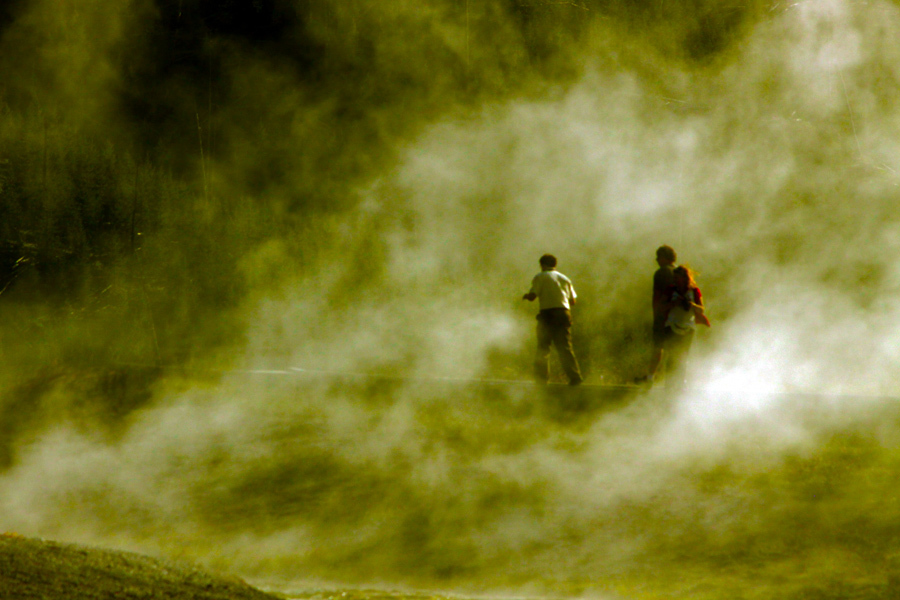 Yellowstone National Park, WY: Poeple navigate pathways over steaming geyser pools :  : Christopher Davies Photography