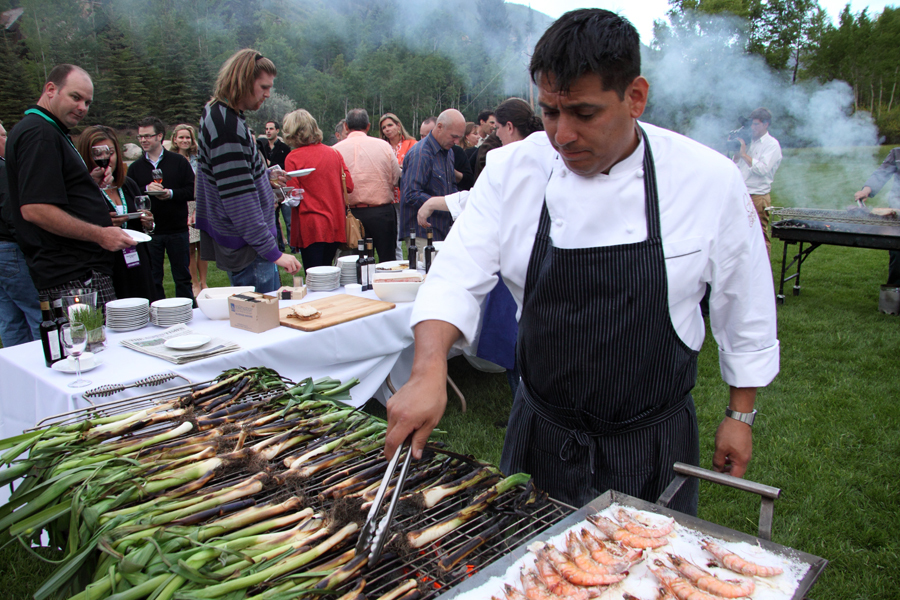 Chef grills BBQ Leek and prawns over salt. Wines of Spain BBQ, Food & Wine Classic Aspen. :  : Christopher Davies Photography